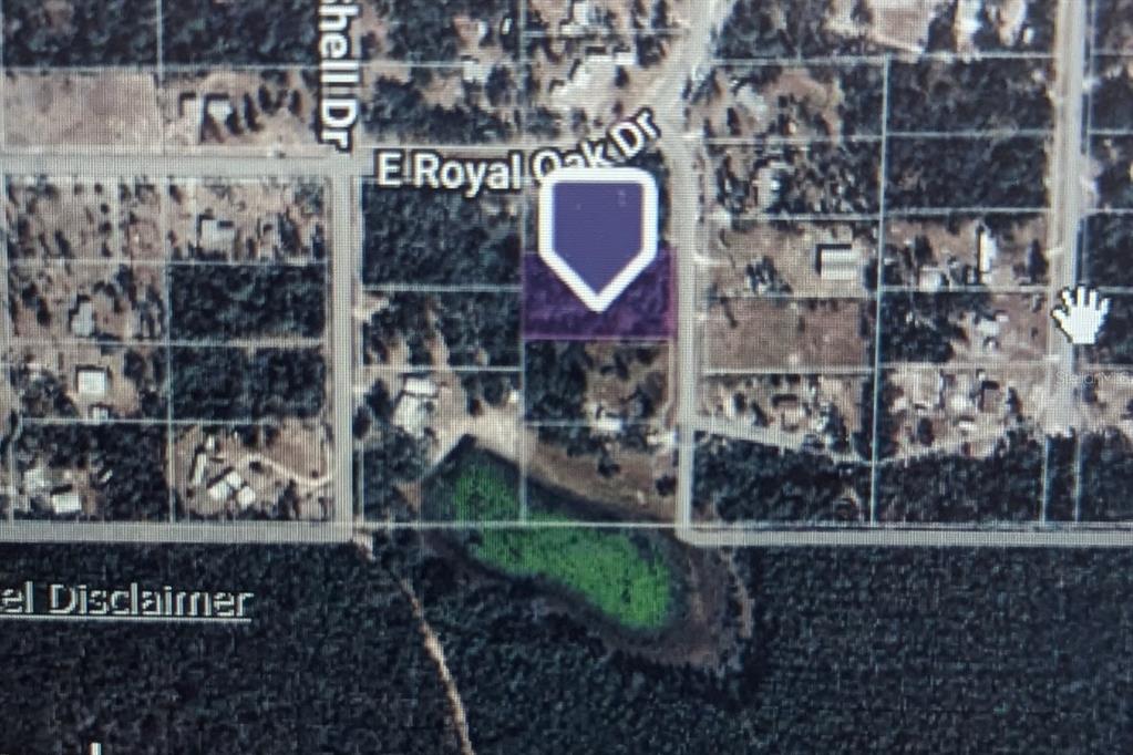 An aerial map view shows a highlighted residential lot located near a small pond — STONE CRAB, PERRY, FL