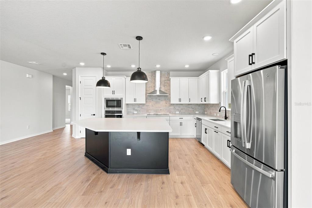 This is a digital rendering of interior design finish samples, including cabinetry, flooring, and countertops — 5117 CHATTAHOOCHEE BEND, ST CLOUD, FL