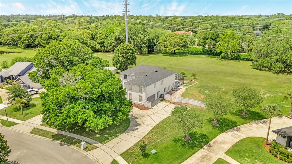 An aerial view shows a two-story house with a driveway and a large backyard — 2152 BLUE IRIS PLACE, LONGWOOD, FL