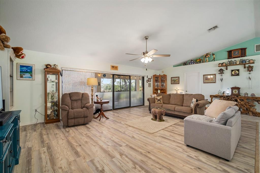 An entryway features a white double door, marble-look tile flooring, and a wooden chest — 1472 IVYDALE ROAD, SPRING HILL, FL