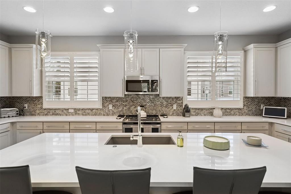 An aerial view of a community swimming pool and hot tub with surrounding lounge chairs — 1495 LAKE GEORGE DRIVE, LAKE MARY, FL