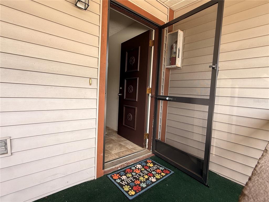 A kitchen features stainless steel appliances, wood cabinets, and a tiled floor — 12155 ENVIRONMENTAL DRIVE UNIT 6, NEW PORT RICHEY, FL