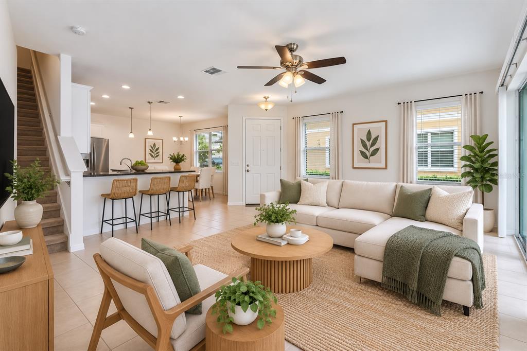 A kitchen features white cabinets, black countertops, a center island, and a dining area — 4240 GUMBO LIMBO DRIVE, ORLANDO, FL