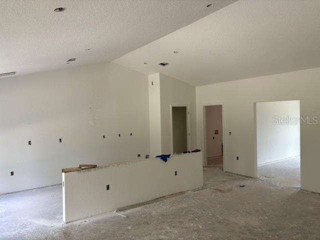 An unfinished interior room features a low partition wall, recessed lighting, and white walls — 6734 SW 179TH AVENUE ROAD, DUNNELLON, FL