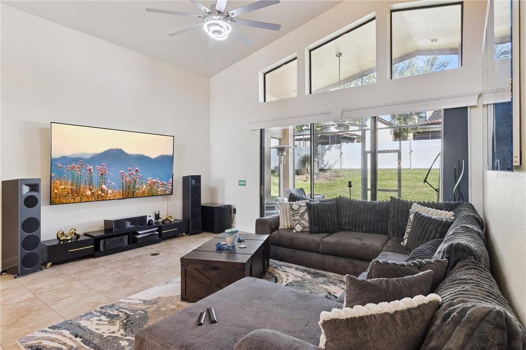 An aerial view shows a house with a tiled roof situated on a corner lot — 3943 SUNSET LAKE DRIVE, LAKELAND, FL