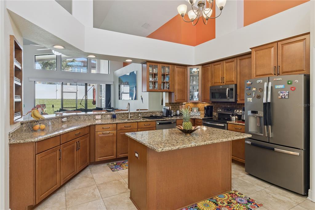 A bright entryway features double glass-paneled doors, a tiled floor, and a large arched window — 3943 SUNSET LAKE DRIVE, LAKELAND, FL