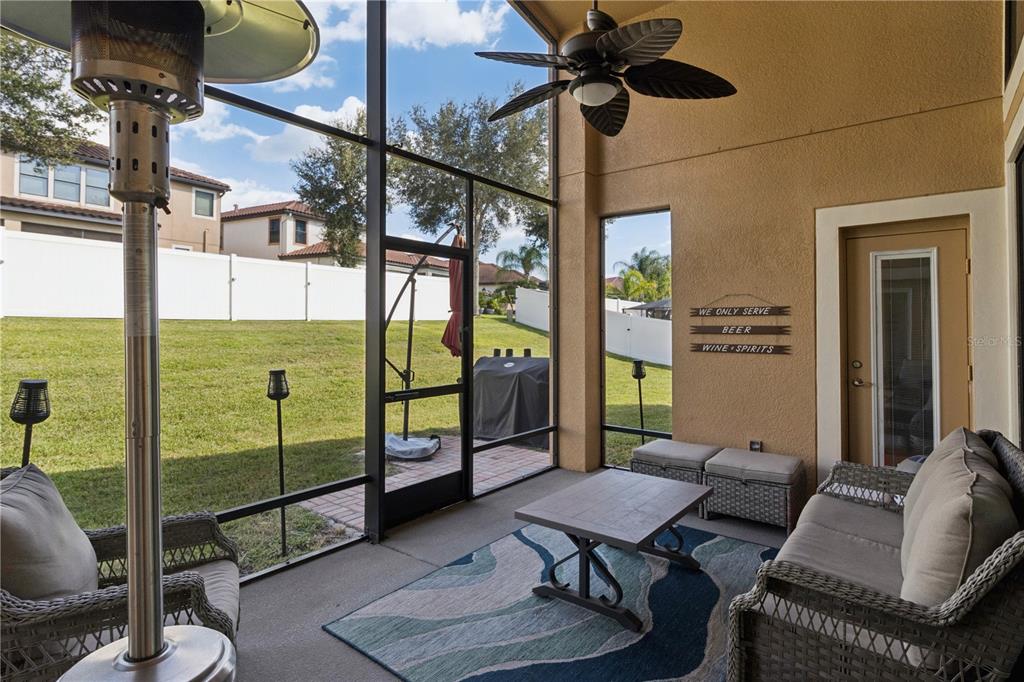 A view from a hallway looking into a kitchen with glass shelves and a living area — 3943 SUNSET LAKE DRIVE, LAKELAND, FL
