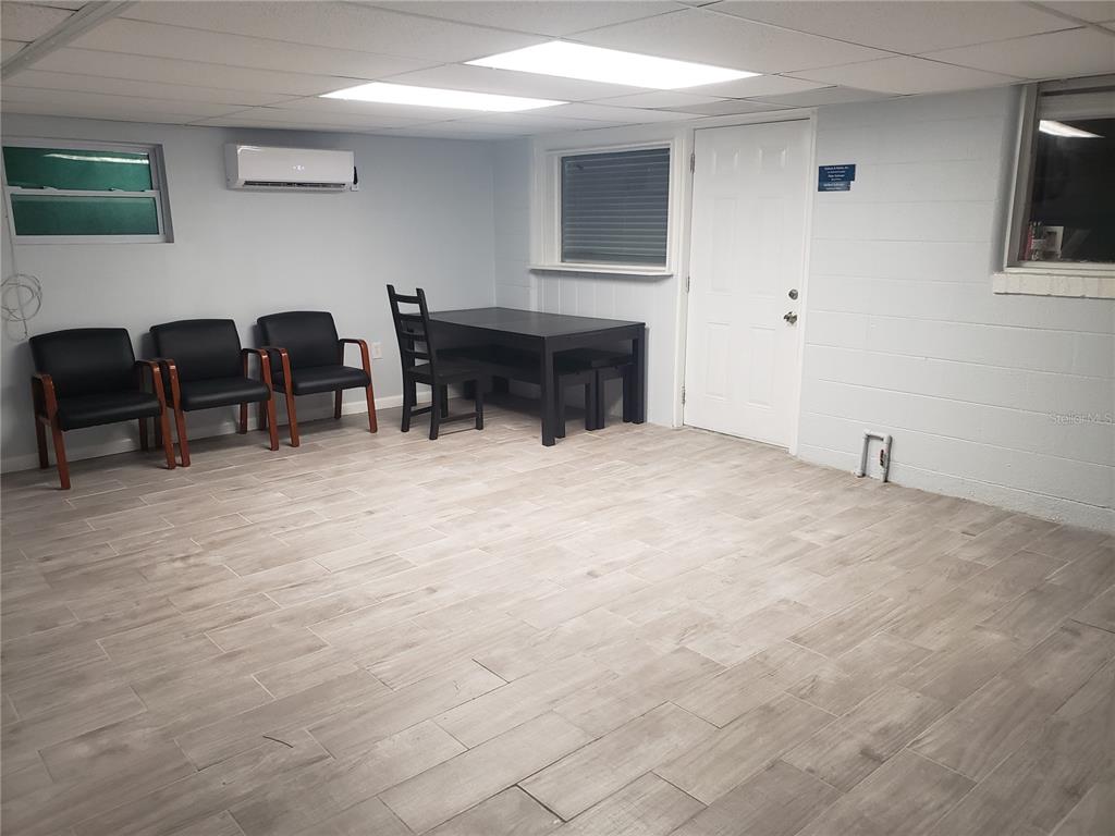 A room with light-colored tile flooring, three black chairs, and a small dining table — 201 W SHELL POINT ROAD, RUSKIN, FL