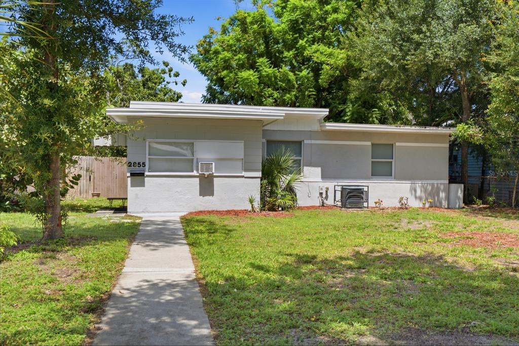 A single-story house with a flat roof, gray exterior, and a concrete walkway — 2855 37TH AVENUE N, ST PETERSBURG, FL