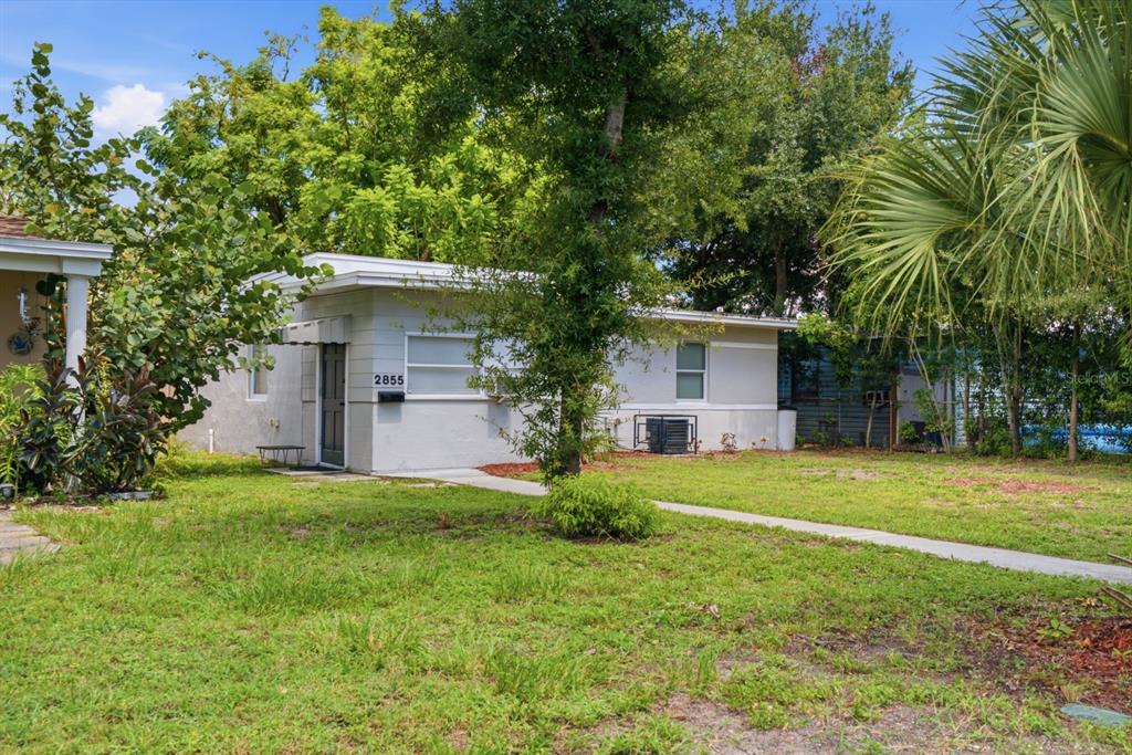 A single-story house with a flat roof, light gray exterior, and a front walkway — 2855 37TH AVENUE N, ST PETERSBURG, FL