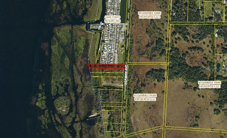This is an aerial map showing a highlighted rectangular land parcel adjacent to a lake — SEAMAN AVENUE, ST CLOUD, FL
