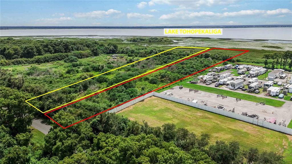 An aerial view shows a wooded lot outlined in yellow and red near Lake Tohopekaliga — SEAMAN AVENUE, ST CLOUD, FL