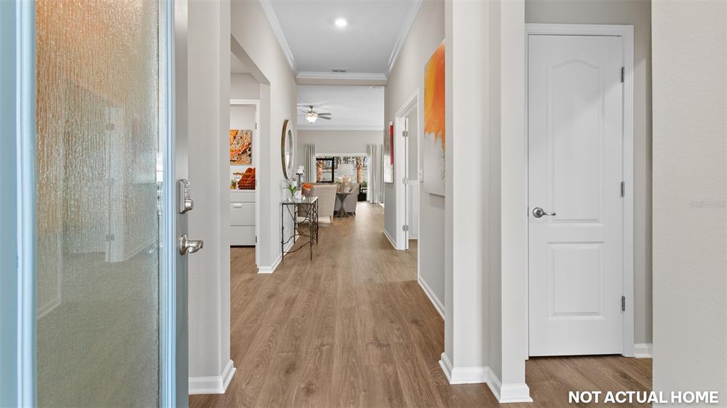 This is a rendering of a home interior featuring a hallway with wood-look flooring — 44 HARDWOOD TRAIL, PALM COAST, FL