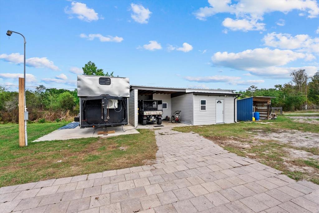 A room with tile flooring, a wooden hutch, and an oval table under a ceiling fan — 8360 SW EASY STREET, ARCADIA, FL