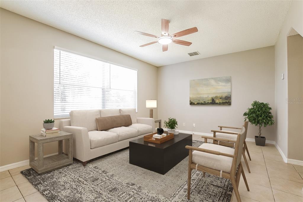 An empty room features beige tile flooring, light-colored walls, and a ceiling fan — 14401 KRISTENRIGHT LANE, ORLANDO, FL