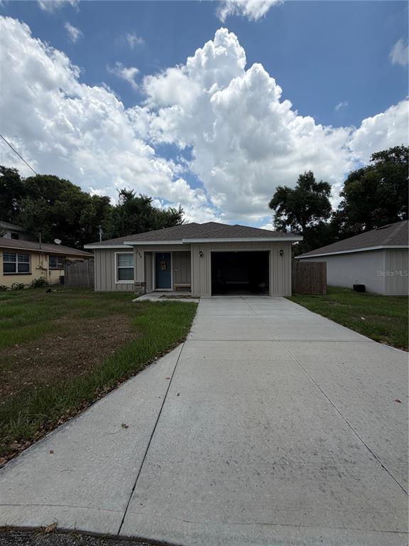 A single-story house features a concrete driveway, a one-car garage, and a light-colored exterior — 350 S 8TH AVENUE, BARTOW, FL