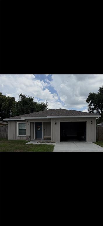 A single-story house with beige vertical siding, a front-facing garage, and a covered entryway — 350 S 8TH AVENUE, BARTOW, FL