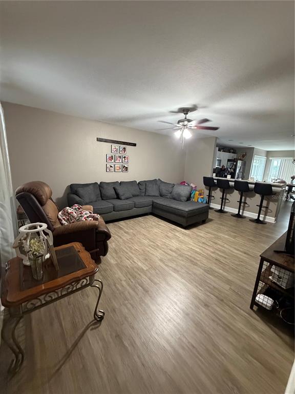 A living room features a grey sectional sofa, a brown recliner, and a kitchen breakfast bar — 350 S 8TH AVENUE, BARTOW, FL