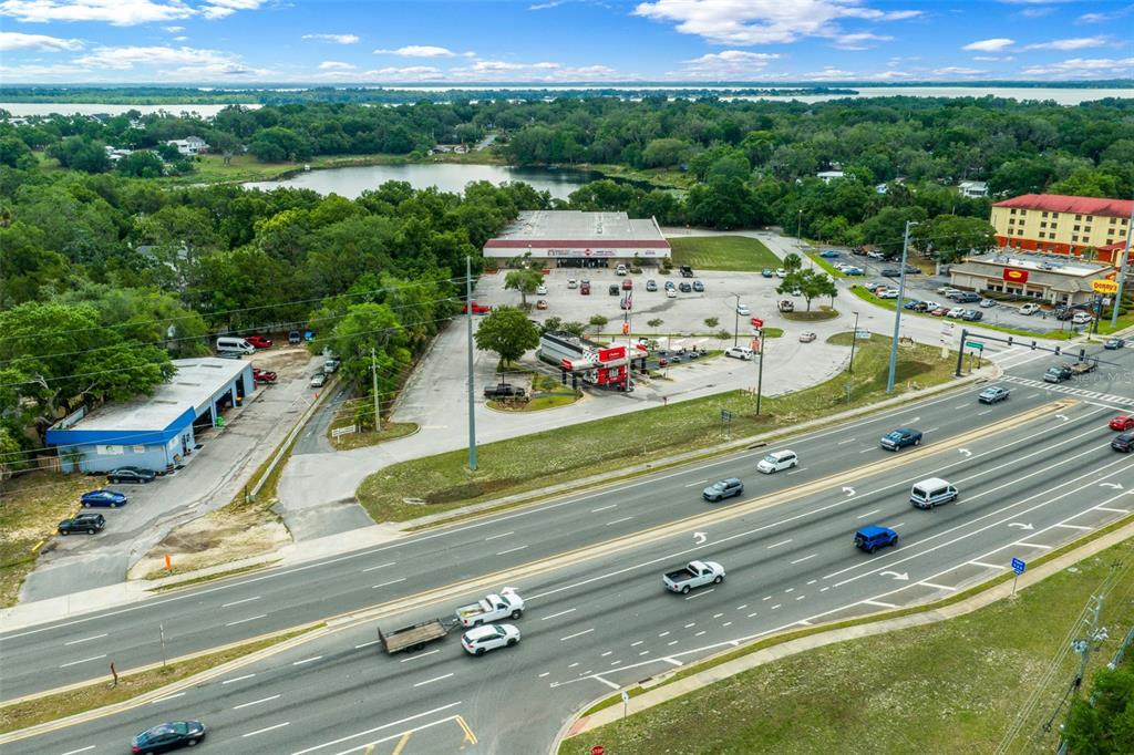 An aerial view shows a commercial plaza with a gas station beside a busy highway — 2500 CITRUS BOULEVARD, LEESBURG, FL