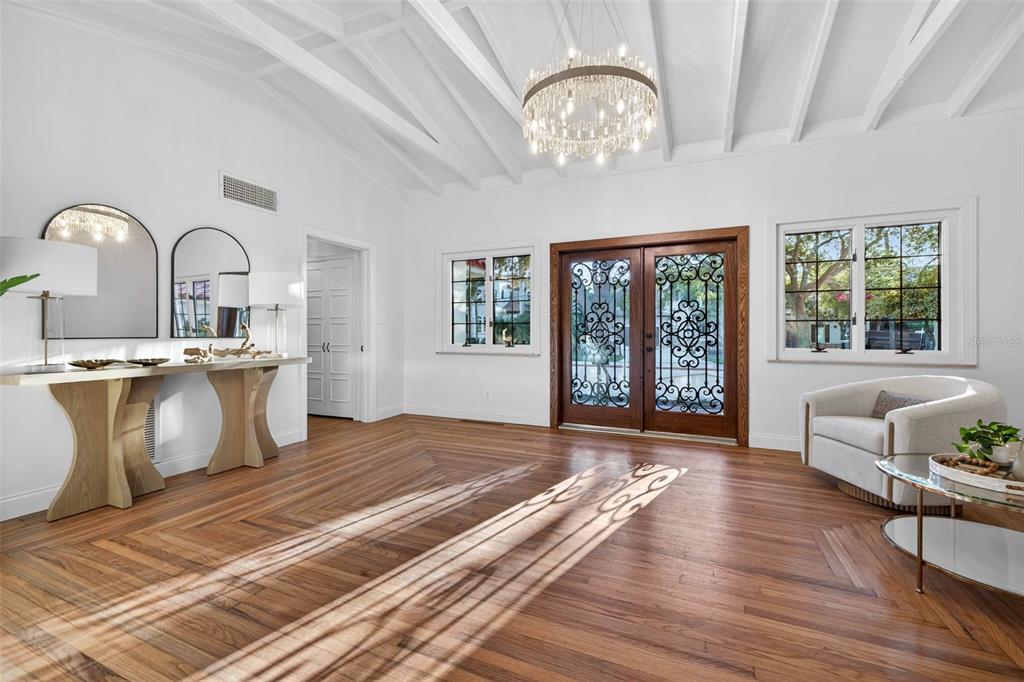 A brick porch with steps leads to a wooden double door with decorative iron grilles — 1222 BRIGHTWATERS BOULEVARD NE, ST PETERSBURG, FL