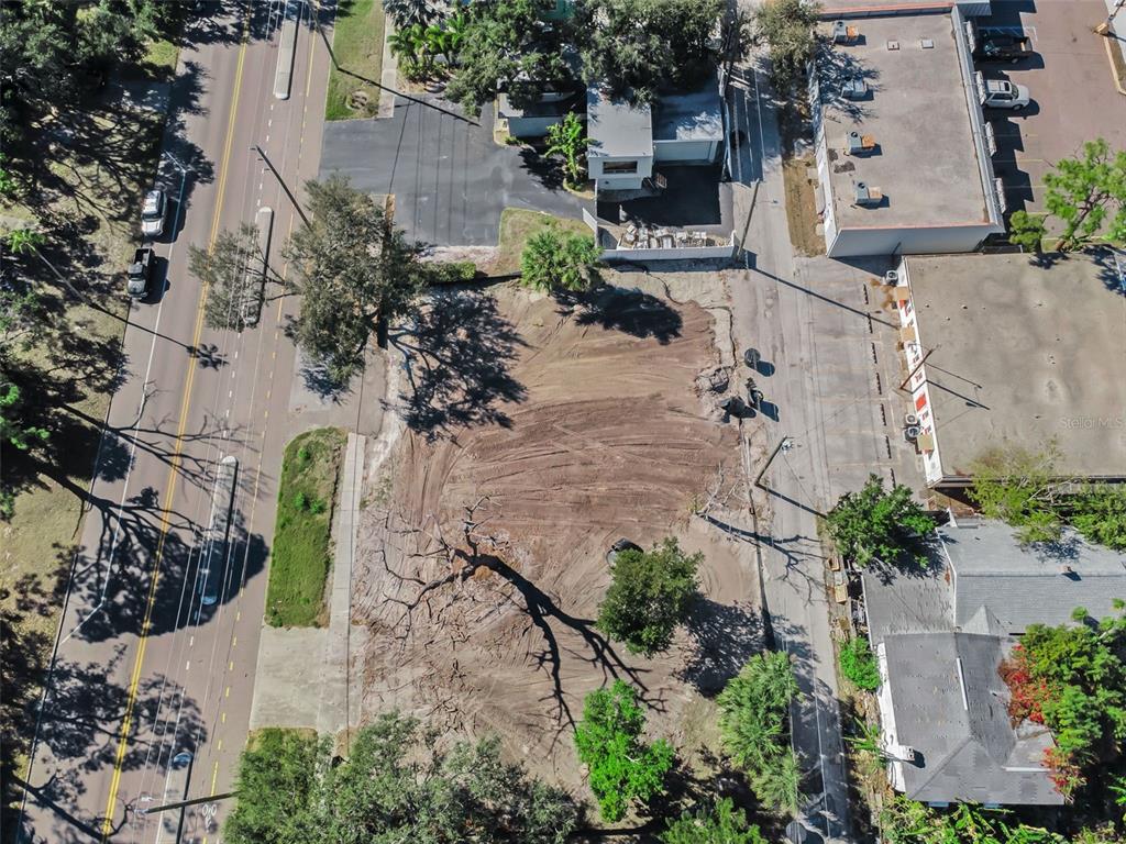 An aerial view highlights a vacant rectangular lot with a small building in a neighborhood — 7301 1ST AVENUE S, ST PETERSBURG, FL