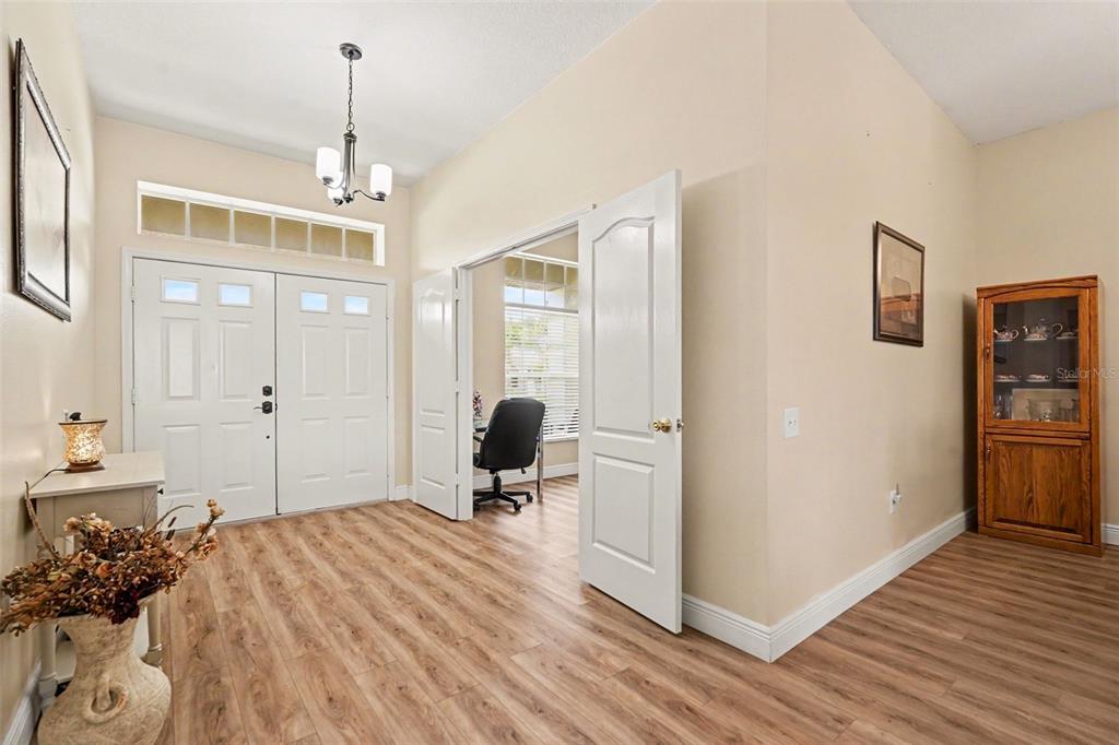 A screened-in patio with tile flooring, outdoor furniture, a grill, and a ceiling fan — 25741 RISEN STAR DR, WESLEY CHAPEL, FL