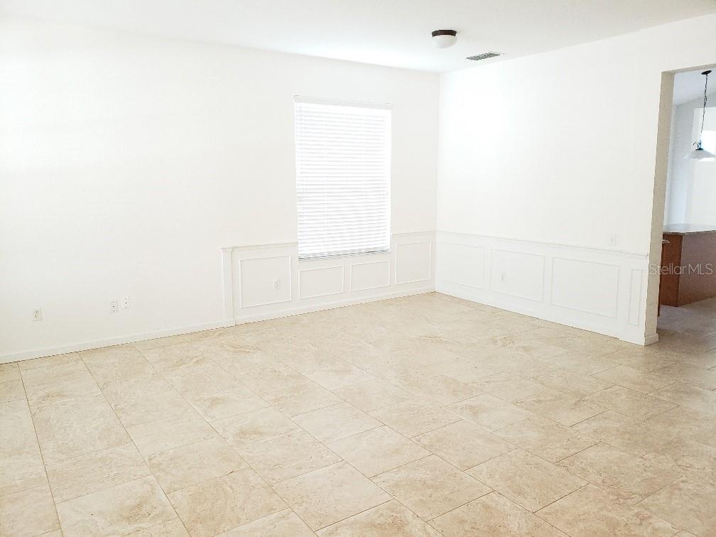 A room with white walls, wainscoting, tile flooring, and a window with blinds — 8625 GREENBANK BLVD, WINDERMERE, FL