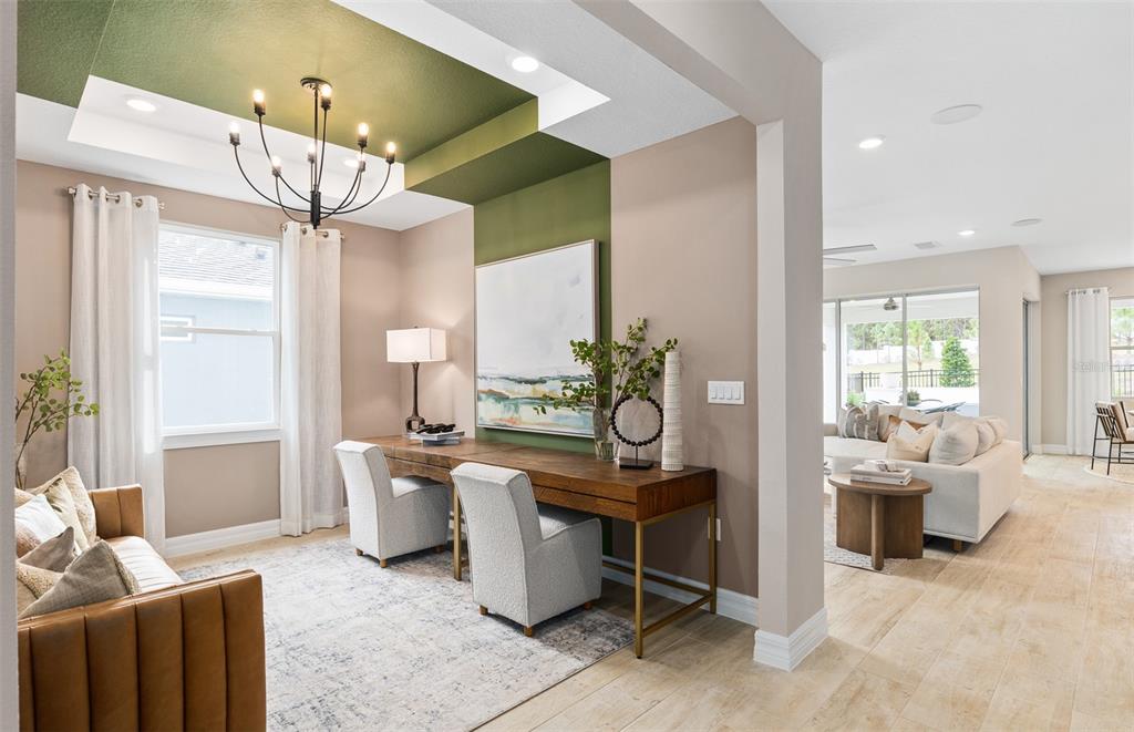 A home office features a green tray ceiling, a long wooden desk, and two chairs — 5095 TWIN LAKES BOULEVARD, ST CLOUD, FL
