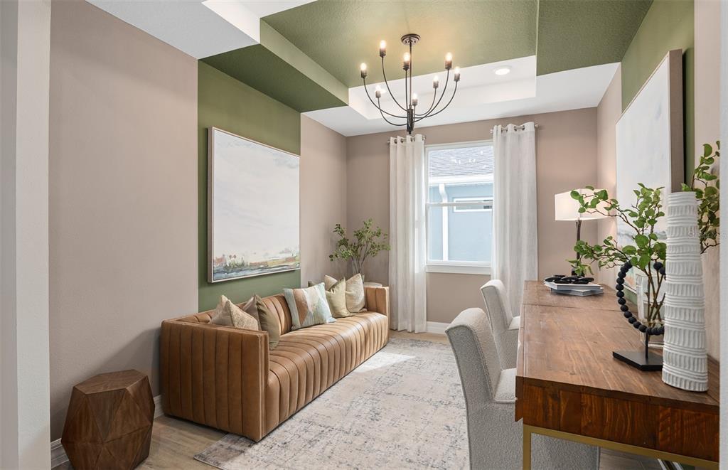 A home office features a tan leather sofa, a wooden desk, and green ceiling accents — 5095 TWIN LAKES BOULEVARD, ST CLOUD, FL