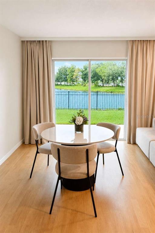 A dining area features a round table with three chairs in front of a sliding door — 2548 HASSONITE STREET, KISSIMMEE, FL