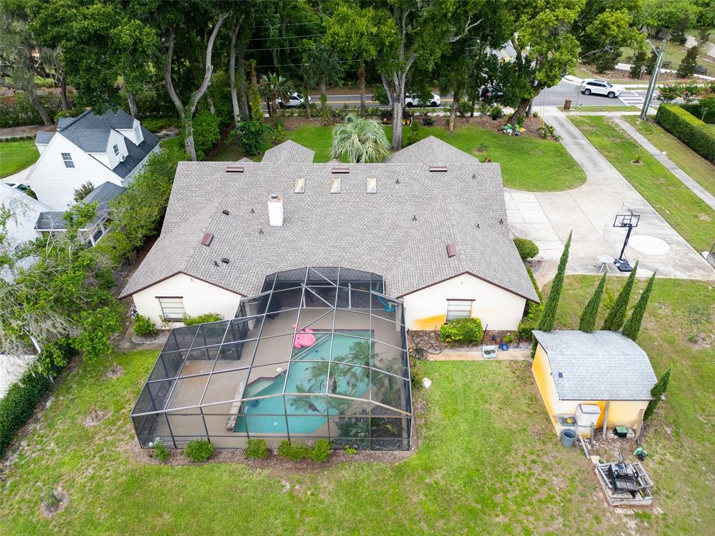 An aerial view shows a house with a screened-in pool and a detached shed — 1407 HEMPEL AVENUE, WINDERMERE, FL