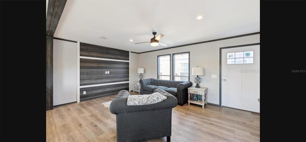 A view from a hallway looking into an open-concept kitchen and dining area — 1636 MISTLETOE STREET, BUNNELL, FL