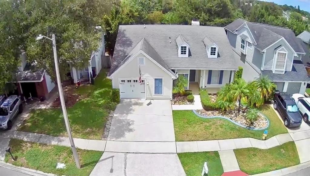 An aerial view of a suburban house with a gray roof, garage, and front lawn — 11838 BRANCH MOORING DRIVE, TAMPA, FL
