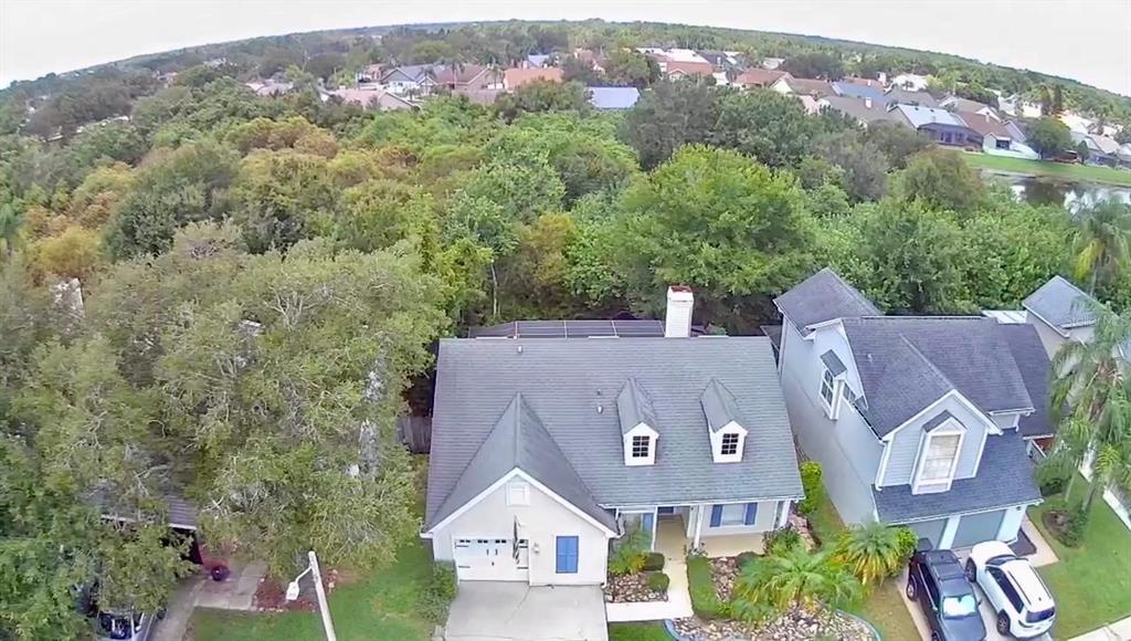 An aerial view of a suburban house with a gray roof and a front garage — 11838 BRANCH MOORING DRIVE, TAMPA, FL