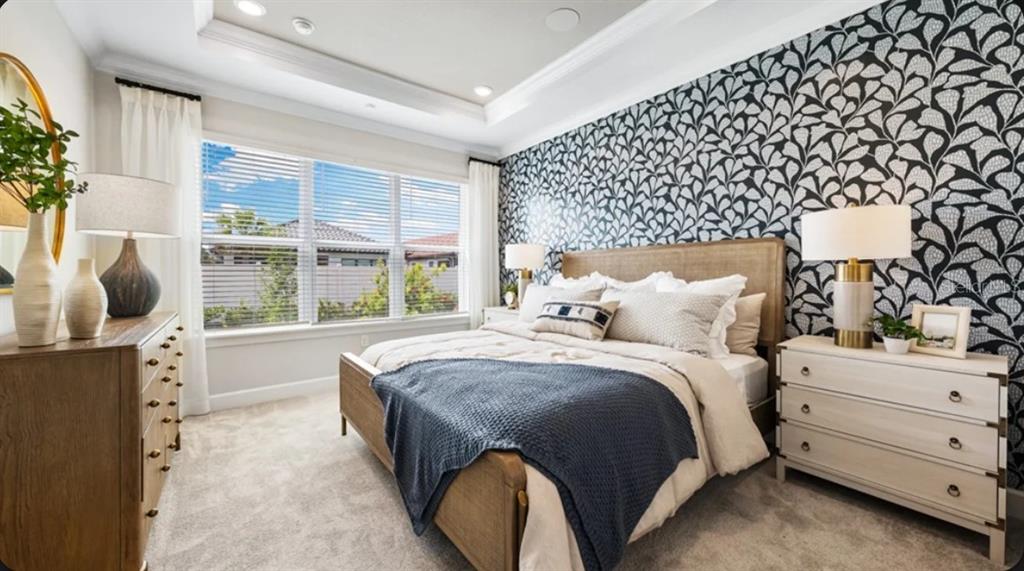 A bedroom features a patterned accent wall, a wooden bed frame, and two bedside tables — 4305 ROSATTI ROAD, WESLEY CHAPEL, FL