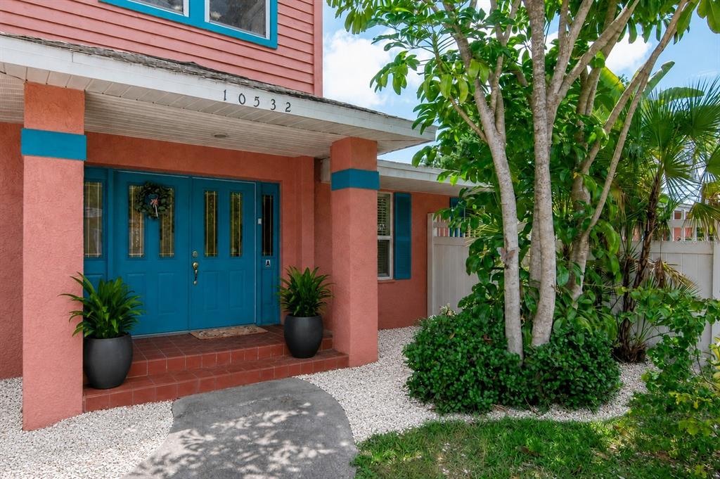 An entryway with tiled floors, a white front door with glass panels, and a staircase — 10532 67TH AVENUE, SEMINOLE, FL