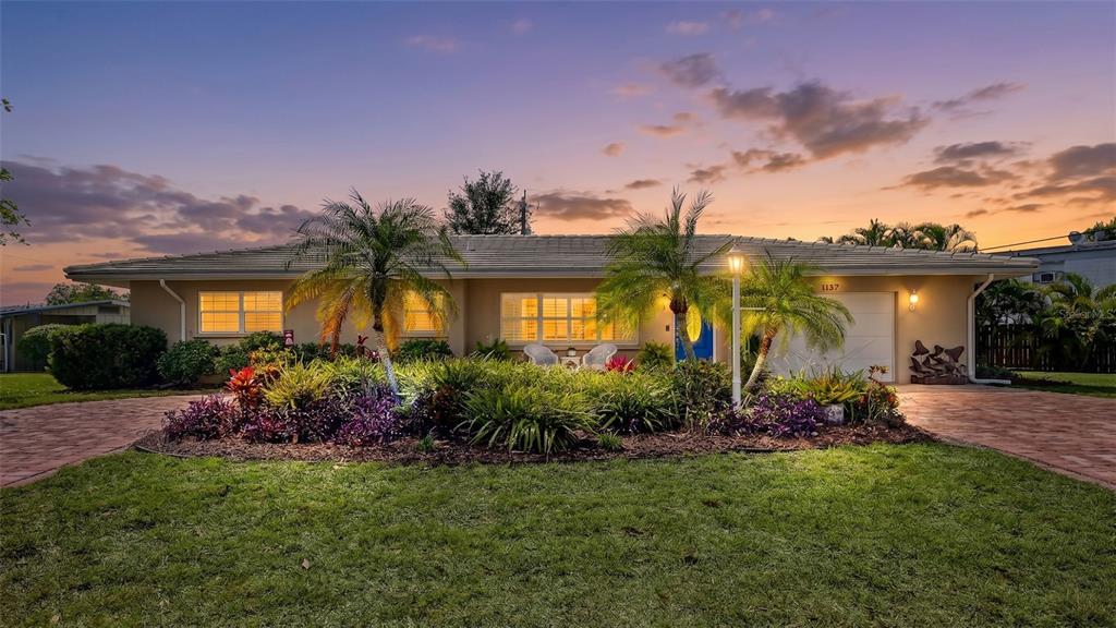 A screened-in patio features a kidney-shaped swimming pool, paver deck, and outdoor dining area — 3537 S SCHOOL AVENUE, SARASOTA, FL