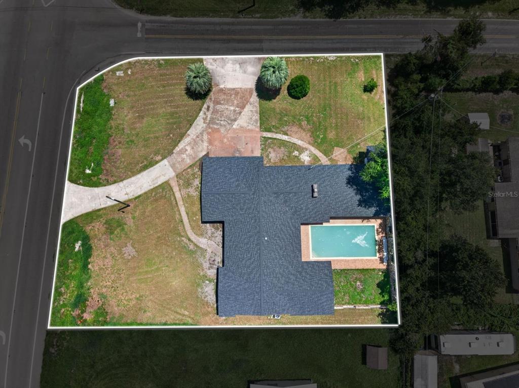 An aerial view shows a house with a swimming pool on a large corner lot — 4448 BETHLEHEM ROAD, DOVER, FL