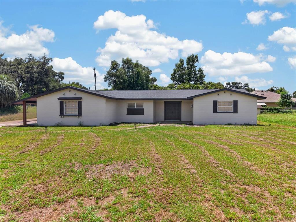 A single-story house with a light-colored exterior, dark shutters, and a dark shingled roof — 4448 BETHLEHEM ROAD, DOVER, FL