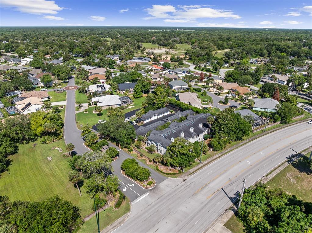 An aerial view shows a residential neighborhood with a multi-unit building near a main road — 596 N NOVA ROAD UNIT 308, ORMOND BEACH, FL
