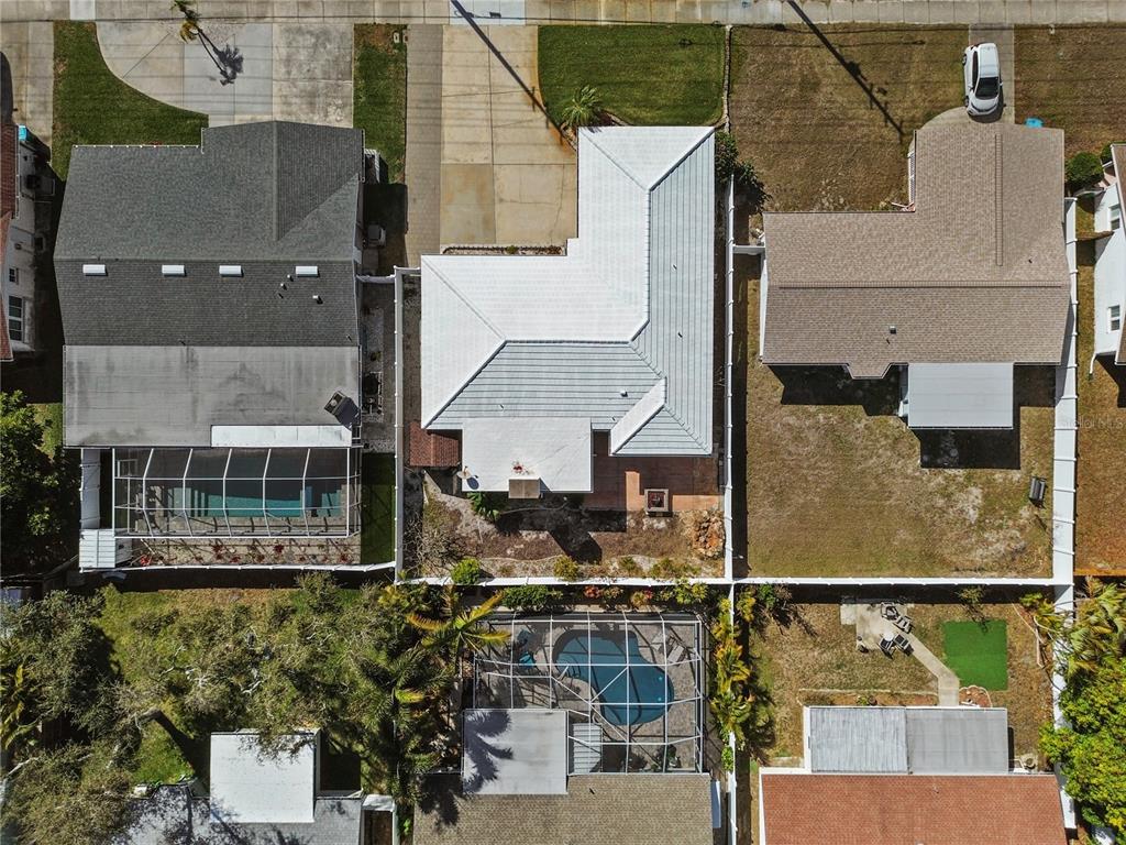 An aerial view shows three suburban houses with pools and fenced backyards — 13565 86TH AVENUE, SEMINOLE, FL
