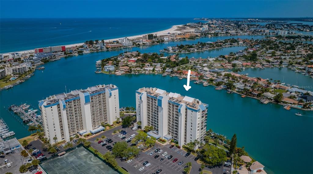 The entrance to the Yacht & Tennis Club of St. Pete Beach features a sign — 9495 BLIND PASS ROAD UNIT 205, ST PETE BEACH, FL