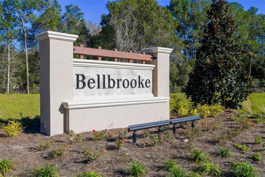 A beige monument sign with the name Bellbrooke stands in a landscaped grassy area — 14330 FIREBIRD DRIVE, JACKSONVILLE, FL