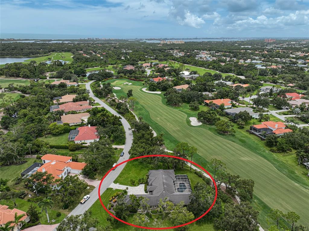 An aerial view of a house with a screened pool enclosure located on a golf course — 852 MACEWEN DRIVE, OSPREY, FL