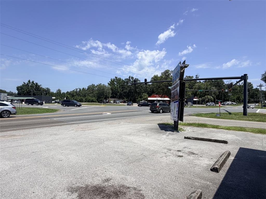 A view of a paved parking lot facing a road intersection with traffic lights — 1005 NW 19TH AVENUE, CHIEFLAND, FL