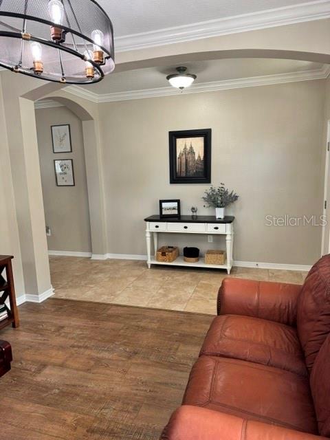 A living area features a leather sofa, a console table, and a large metal chandelier — 8221 NECTAR RIDGE COURT, ODESSA, FL
