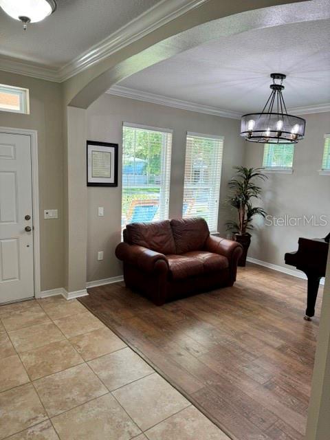 A living area features a brown leather loveseat, wood-look flooring, and a chandelier — 8221 NECTAR RIDGE COURT, ODESSA, FL