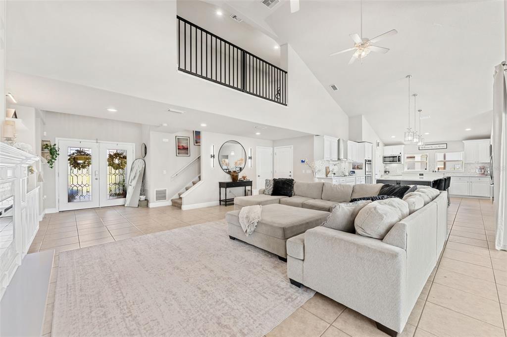A covered patio with a pool, water fountains, and outdoor seating overlooking a grassy yard — 3897 PROVINCE DRIVE, MELBOURNE, FL