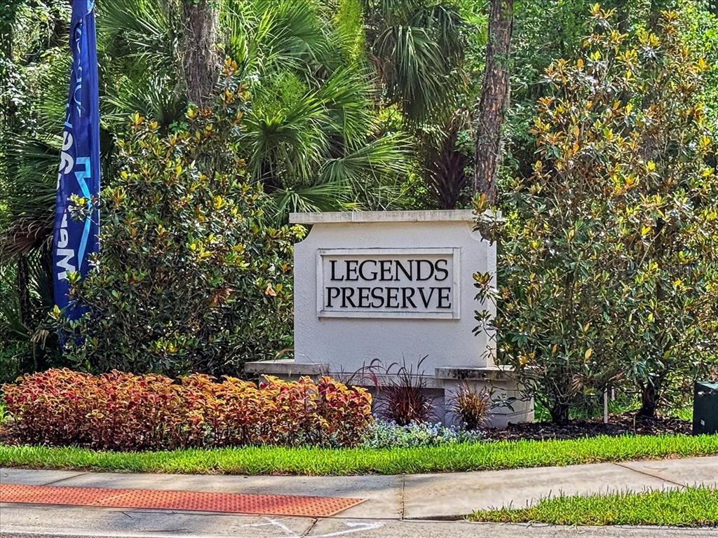 A stone monument sign for Legends Preserve stands in a landscaped area with trees — 3149 LEGENDS PRESERVE DRIVE, DAYTONA BEACH, FL