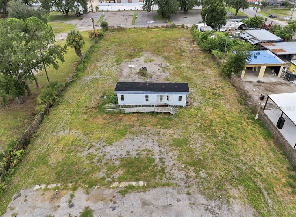 An aerial view shows a single-story mobile home with a ramp on a large lot — 4946 E HILLSBOROUGH AVENUE, TAMPA, FL
